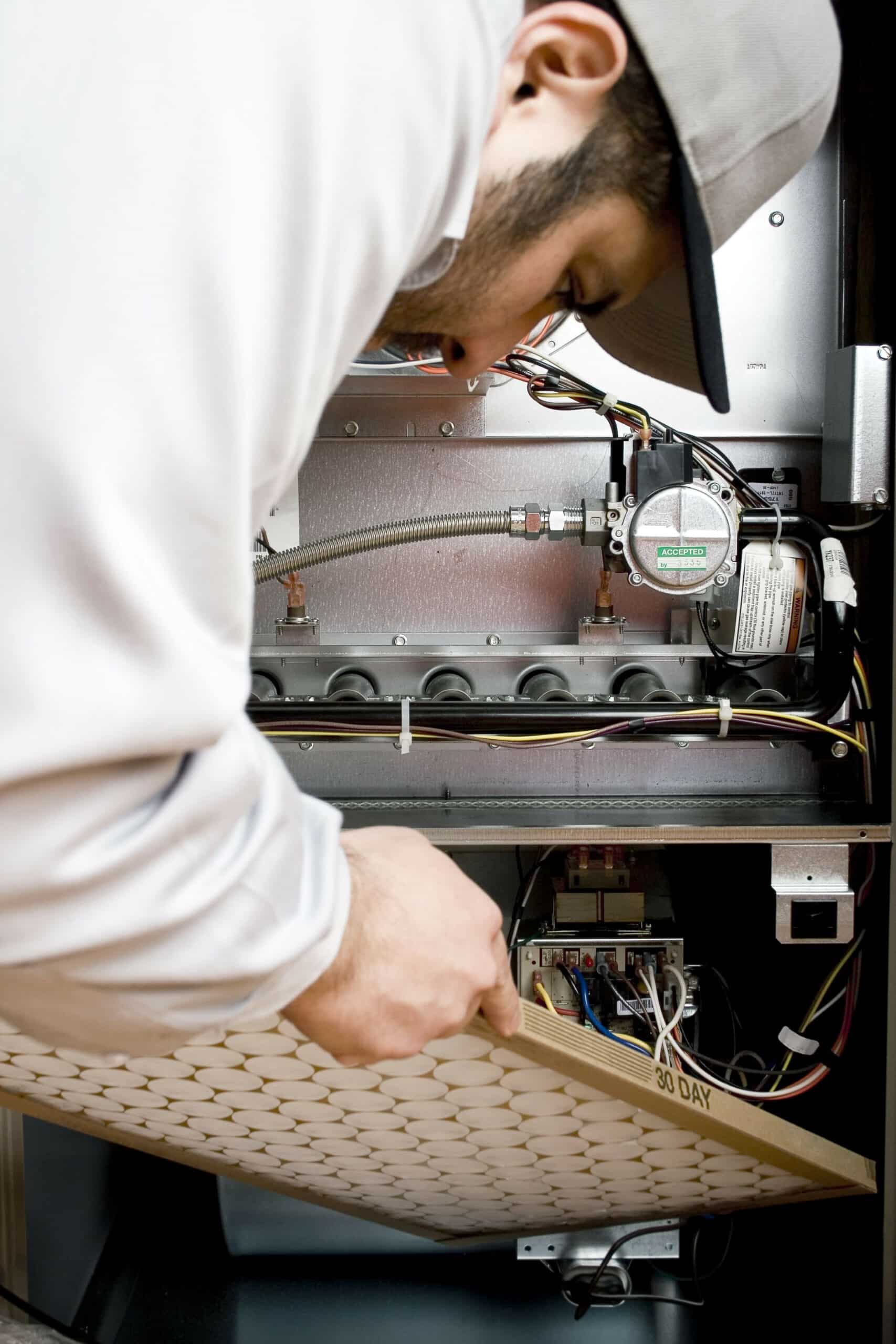 technician replacing furnace filter in colorado springs, co.
